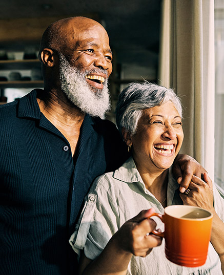 Senior couple drinking coffee in kitchen