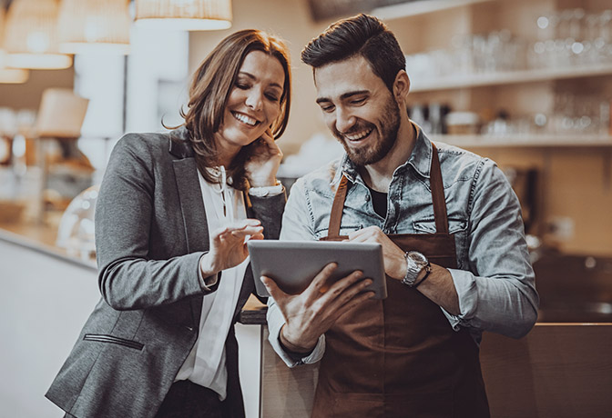 Business owners looking at tablet