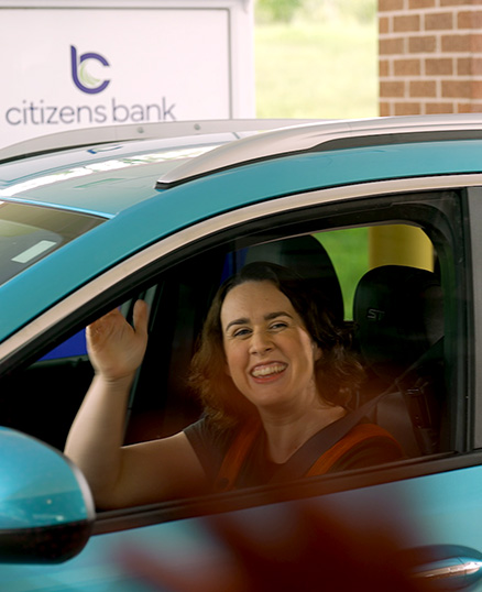 Woman at drive up window waiving