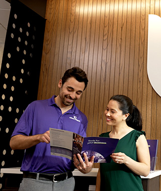 Two people looking at a brochure
