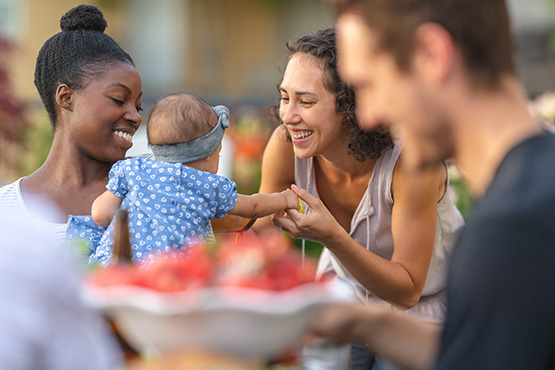 Friends talking with a baby