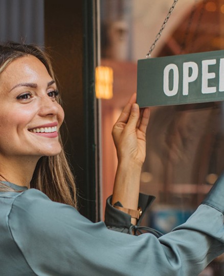 Woman flipping here sign to open