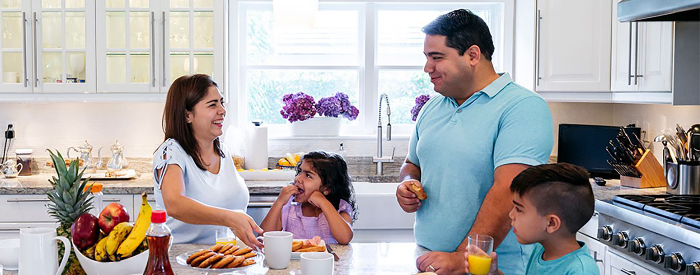 Family talking in kitchen